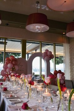 a long table is set with candles and balloons