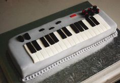 a cake decorated with an electronic keyboard on top of a table