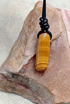 Tigers Eye stone necklace with adjustable cord. Perfect idea for gift. 1)-Stone size -18.5x17.5mm leather cord -2mm 1)-Necklace length 14"-28"(adjustable) --------------------------------------- 2)-Stone size -10.5x33mm (long shape) leather cord -2mm  (2)- necklace length 15"-30" adjustable (approx.) *Tiger Eye The zodiac stone for June, tiger's eye is in the quartz family. .it is, in fact, a good luck bringing stone that protects the wearing from evil thoughts and all ill wishes of enemies.it also possesses many healing properties. .Tiger Eye reduces the chronic pains, improves the strength of spines, and detoxifies the body. .It boosts up your confidence level. .It gets you mental clarity and decidedness. Brown Adjustable Cord Jewelry For Healing, Minimalist Waxed Cord Jewelry As Gift, Spiritual Cord Necklaces For Gifts, Spiritual Cord Necklaces As Gifts, Spiritual Cord Jewelry For Gifts, Spiritual Cord Necklace Gift, Spiritual Cord Necklace For Gift, Healing Waxed Cord Necklace With Adjustable Cord, Waxed Cord Pendant Necklace Gift