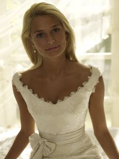 a woman in a white dress posing for the camera