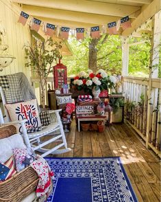 the porch is decorated with red, white and blue decorations