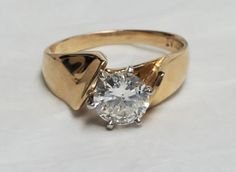 Lady's 14k yellow gold ring, with one GH color, I-1 clarity, round brilliant cut diamond. The diamond weighs approximately 1.00 carat, measures 6.22 mm wide by 6.33 mm long, and is 6-prong head set in 14k white gold in the center of the ring. Sizing done at goldsmith's discretion. Yellow Gold Diamond Ring, Head Set, Ladies Diamond Rings, Gold Diamond Ring, Ring Pictures, Gold Diamond Rings, Yellow Gold Ring, Round Brilliant Cut Diamond, Round Brilliant Cut