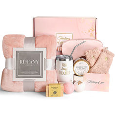 the pink hamper is packed with items like soap, candles, and other personal care products