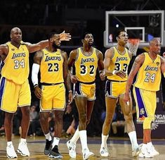 the los angeles lakers are standing in a line on the court with their arms around each other