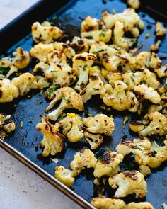 roasted cauliflower on a baking sheet ready to be cooked in the oven,