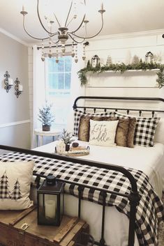 a black and white checkered bed in a bedroom with a chandelier above it