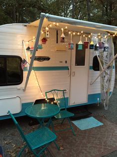 a camper with lights strung from it's roof