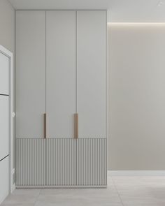 an empty room with white walls and cupboards