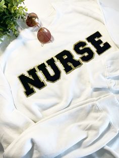 Looking for the perfect gift for a nurse or nursing graduate? Look no further than our Nurse sweater and Nurse sweatshirt featuring a Chenille patch design. These comfortable and stylish Rn sweatshirts make the perfect Nurse appreciation gift or New nurse gift. Show your appreciation for the hard work and dedication of nurses with this unique and thoughtful gift. There are made of 60% cotton, 40% polyester and dry quickly and drape nicely around you. Create the PERFECT sweatshirt! Patches are ironed on, then sewn with a sewing machine to reinforce.  DETAILS: -Sweatshirt is 60% cotton, 40% polyester -Sizes: From Small to 3XL. -Fit: UNISEX (For Women is Oversized). -Letters are made of Chenille fabric, approximately 3.1 inch height (Black letters) 2.7 inch height (white letters),  Available White Crew Neck Sweatshirt With Letter Patch, Fall Nursing Sweatshirt With Crew Neck, Cotton Sweatshirt For Nursing In Fall, Cotton Nursing Sweatshirt For Fall, Sweatshirt Patches, Chenille Patch Sweatshirt, New Nurse Gift, Nurse Sweater, Patch Sweatshirt