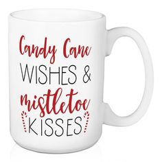 a white coffee mug with candy cane wishes and mistlet kisses on the inside side