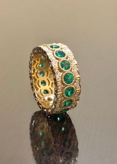 DeKara Designs Collection Metal- 18K Yellow Gold, .750. Stones- 17 Genuine Round Emeralds 1.90 Carats, 102 Round Diamonds F-G Color VS1 Clarity 0.42 Carats. Entirely Handmade 18K Yellow Gold Eternity Diamond Round Emerald Engagement Band. This band is extremely elegant featuring round fiery, and beautiful green emeralds that are all professionally burnish set individually with amazing bead work surrounding each stone. There are 51 professionally pave set round diamonds on the top and bottom of b Luxury Yellow Gold Emerald Ring For Wedding, Emerald Wedding Jewelry With Pave Setting, Luxury Emerald Wedding Ring For Anniversary, Luxury Moissanite Jewelry For Marriage, Luxury Emerald Wedding Jewelry, Exquisite Jewelry With Pave Setting For Weddings, Heirloom Jewelry With Pave Setting For Wedding, Heirloom Wedding Jewelry With Pave Setting, Emerald Band Ring