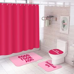 a bathroom with pink rugs and red shower curtain in the corner next to a toilet