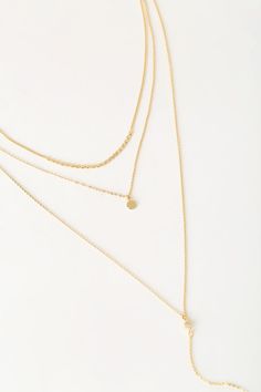 Lulus Exclusive! The Lulus Coretta Layered Gold Necklace is here to make your outfit perfect! Three layers of dainty gold chains, embellished with a row of round charms, a circle charm, and a drop chain embellished with a single rhinestone and bar charm, all come together to create a simple yet sweet look. Lobster clasp closure. Shortest necklace measures 13" long, with 4" drop chain, and a 2. 25" extender chain. Man made materials. Imported. Lulus | Coretta Layered Gold Necklace. Charm Necklace With Delicate Chain And Round Pendant, Dainty Gold Layered Charm Necklaces, Gold Dangle Layered Necklace With Delicate Chain, Gold Layered Dangle Necklace With Delicate Chain, Gold Minimalist Layered Dangle Necklace, Minimalist Gold Layered Dangle Necklace, Dainty Gold Round Layered Necklace, Dainty Layered Dangle Necklace For Layering, Delicate Gold Layered Chain Necklace