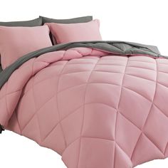 a pink comforter set with two pillows on the bottom and one pillow in the middle