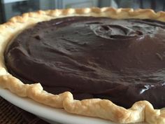 a chocolate pie sitting on top of a white plate