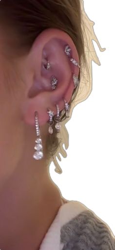 a close up of a person wearing ear piercings