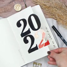 a person holding a book with the number twenty two on it next to other items