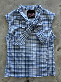 flat lay of blue plaid bow top Bow Front Top, 60s Tops, Nostalgia Fashion, Blue Clothes, Blue Outfits, Vintage Inspired Clothing, Unique Pockets, Bow Top, Unique Top