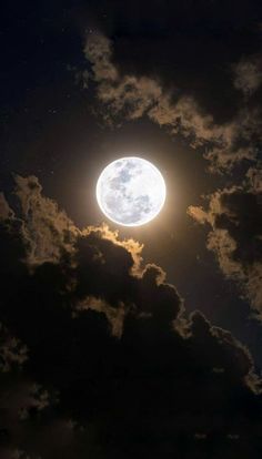 the full moon is shining brightly in the night sky, with clouds and stars around it