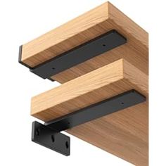 two wooden brackets are attached to the side of a wall