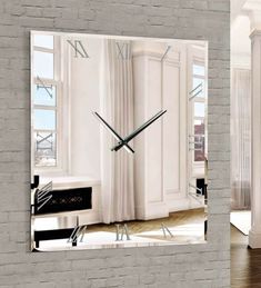 a large clock mounted to the side of a brick wall next to a living room