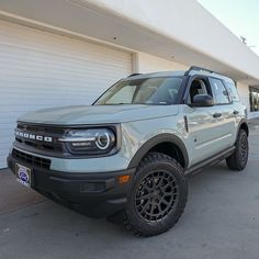 a white truck parked in front of a garage