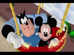 two mickey mouses are riding on a swing