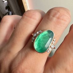 Holy Moly this is a RING. A stunning rosecut Zambian Emerald is set in buttery 14k yellow gold. Accented with over 1/4th of a ct of Brilliant white diamonds and Emily's seagrass band this is truly a ring that will be forgotten. Approx stone size: 18mm x 11mm Approx ct weight: 4.7cts Approx diamond ct: .26cts Mohs hardness: 8 This one of a kind piece is handmade with love in Emily's Hudson Valley studio. It is currently in stock and ready to size and ship. If you have questions about sizing, ship Emerald Cocktail Ring, Emerald Cocktail, Alternative Engagement Ring, Holy Moly, Zambian Emerald, Local Jewelry, Alternative Engagement Rings, Diamond Jewellery, Hudson Valley