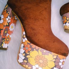 Elevate your style with the Suede Floral Platform Boots, a spin-off of the best-selling Suede Platform Heels. These boots feature a stunning '70s-inspired floral print on the platform, combining vintage charm with contemporary flair. Stunning '70s-inspired floral print on the platform for a unique and eye-catching look Crafted from high-quality suede for a luxurious feel and durability Perfect for nights out or adding retro glamour to everyday outfits. Vintage Multicolor Boots For Fall, Retro Chunky Platform Boots For Fall, Retro Platform Boots With Chunky Platform For Fall, Multicolor Retro Boots For Fall, Retro Multicolor Boots For Fall, Vintage Ankle Boots For Spring, Retro Heeled Boots For Party In Fall, Brown Floral Print Boots For Fall, Vintage Brown Boots For Party