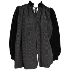 This is a stunning Yves Saint Laurent YSL black on black Velvet sleeved Jacket. Mandarin Collar with tassel cord closure. Balloon sleeves.. Banded cuff 2 slit hidden pockets. Labeled a Size 34 Measuring approximate up to a 42 chest -- Open waist -- 26.5 long. Will fit a 6-10. Measurements and sizes are approximate. Be sure to check our store front for more fabulous pieces from this collection. We have been selling this collection on 1st dibs since 2013. You can Follow us via storefront as well! Saint Laurent Jacket, Velvet Sleeve, Designer Jackets, Evening Jackets, Jacket Design, Black Silk, Vintage 1970s, All About Fashion, Black Velvet