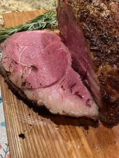 a piece of meat sitting on top of a wooden cutting board