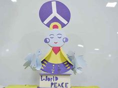 a paper sculpture with a peace sign on top