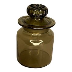 a glass jar with a metal lid on a white background