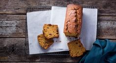 a loaf of bread sitting on top of a cooling rack next to two pieces of bread