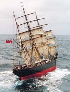 an old sailing ship in the middle of the ocean