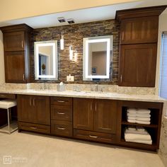 a bathroom with double sinks and two mirrors on the wall next to eachother