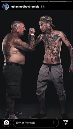 two men standing next to each other with tattoos on their body and arms, one holding a beer