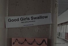 there is a sign on the wall that says good girls swallow