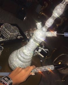 a person holding onto a large crystal vase with many diamonds on it's sides