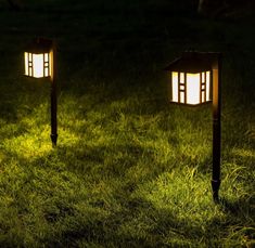 two lights that are sitting in the grass