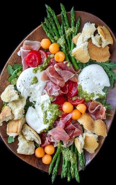 a plate filled with different types of food on top of a wooden table next to an instagram post