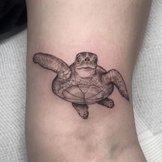 a small turtle tattoo on the ankle