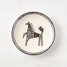 a black and white plate with a dog on it