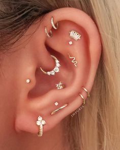 an ear with five different types of piercings