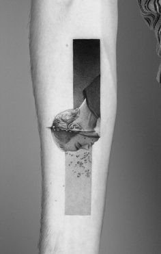 a man's arm with a black and white photo of a bird on it