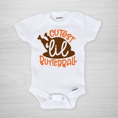 "Cutest Lil Butterball" Thanksgiving Day super soft Gerber Onesie®!﻿ Leave a note if you need any color or wording changes. Details:· Genuine Gerber Onesies® decorated with Pipsy artwork. · See size chart in photos.· Gerber Onesies® tend to run small, so size up if in doubt.· Hand pressed and printed in our Nashville studio.· Printing is done with water-based, certified child-safe inks.· Leave a note if you need any custom changes. Timing:· Items take approximately 3 business days to make.· Ship Thanksgiving Baby Onesie, Butterball Turkey, Thanksgiving Onesie, Thanksgiving Baby, Personalized Plates, Vinyl Shirts, Pretty Eyes, Future Baby, Gender Neutral Baby