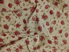 an image of a flowered fabric with red flowers on it