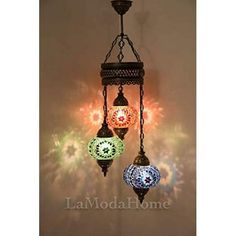 three colorful lights hanging from a chandelier