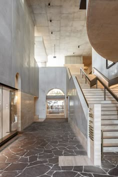 an empty building with stone floors and stairs