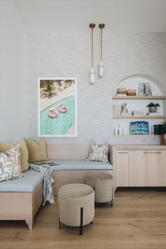 a living room filled with furniture and a painting on the wall